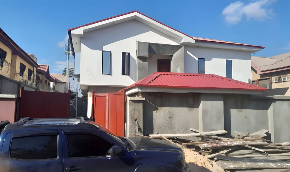 After: remodelled facade and red roof canopy — Alapere, Lagos