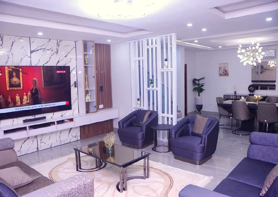 Living room with TV wall, seating and recessed ceiling — Gbagada, Lagos