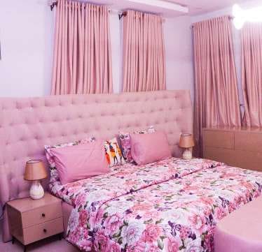 Bedroom with pink upholstered headboard and curtains — Gbagada, Lagos
