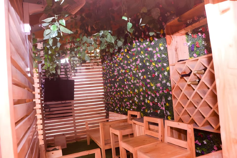 Timber gazebo interior with seating and bottle storage — Gbagada, Lagos