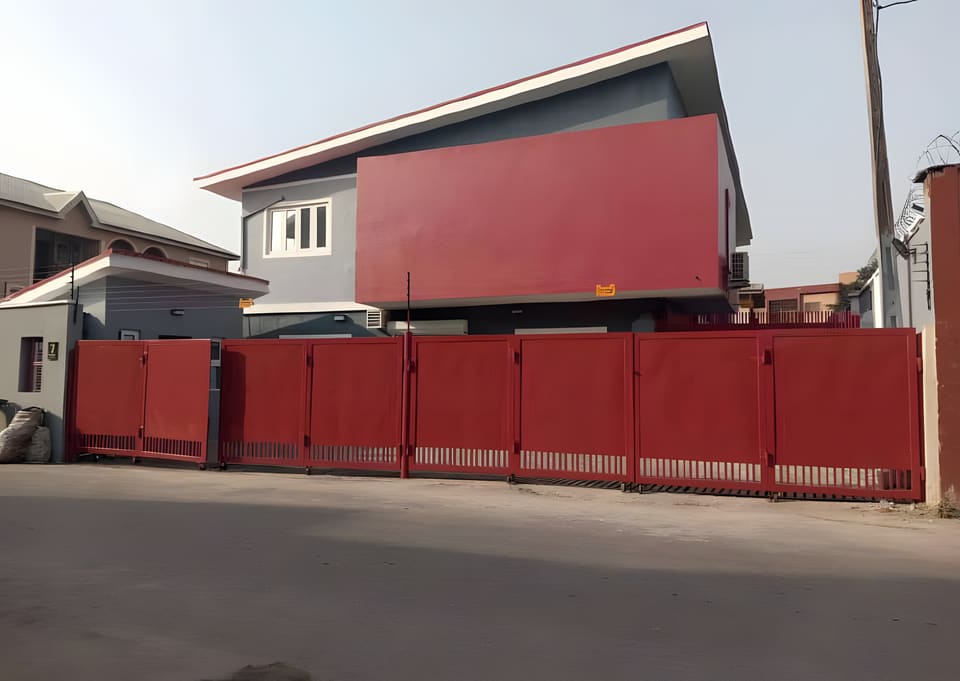 After: remodelled office facade and red entrance gate — Oluwaleimu Street, Ikeja, Lagos
